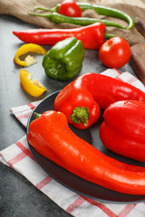 Fresh colorful chilies in a black ceramic plate.