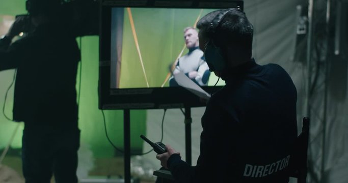 Director giving instructions and watching the scene on monitor