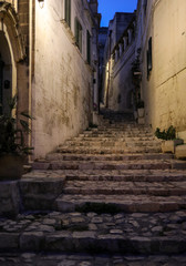 Typical cobbled stairs in a side street alleyway iin the Sassi di Matera a historic district in the city of Matera. Basilicata. Italy
