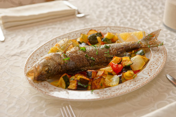 Grilled sea bass on restaurant table