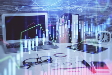 Double exposure of chart and financial info and work space with computer background. Concept of international online trading.