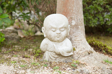 Fototapeta na wymiar Photograph of a small concentrated Buddha statue