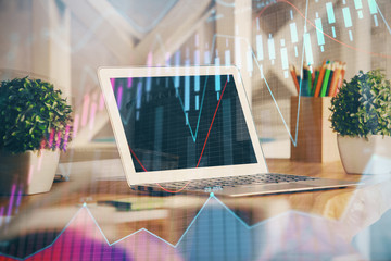 Financial graph colorful drawing and table with computer on background. Multi exposure. Concept of international markets.