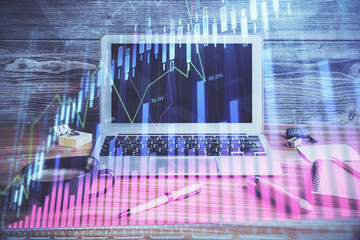 Multi exposure of graph and financial info and work space with computer background. Concept of...