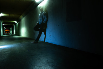 Ghost man leaning against tunnel wall