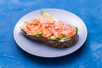 Sandwich with smoked salmon and cucumber. Concept for healthy nutrition.