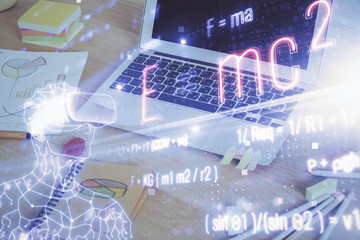 Desktop computer background and formula hologram writing. Double exposure. Education concept.
