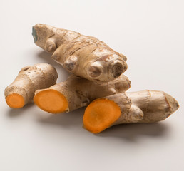 Cutting or sliced turmeric curcuma root on white