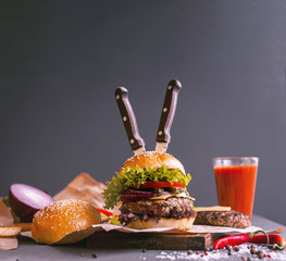 Delicious fresh homemade burger on a wooden table