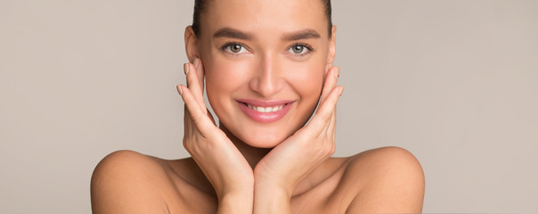 Beauty and skin care. Pretty girl touching her perfect clean skin
