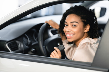 Happy Black Lady Doing Test Drive Posing Sitting In Automobile