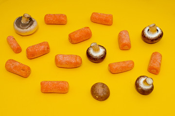 Flat-lay of fresh organic Carrots and mushrooms. vegetable ingredients top view