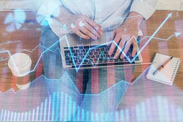 Forex graph with businessman working on computer in office on background. Concept of analysis....