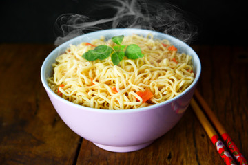 bowl of hot noodles on the wooden floor