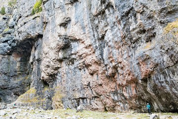 Hiker inside Gordale Scar, Malham, North Yorkshire.