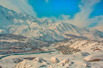 high angle view of a town in valley covered with snow in winter