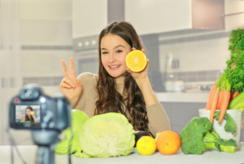 Teenage blogger explains to her followers how to eat healthy. Concept of communication among young...