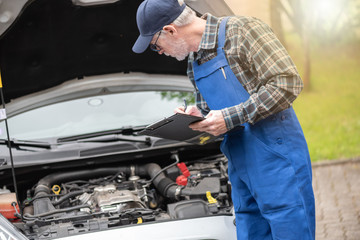 Fototapeta premium Car mechanic checking a car engine
