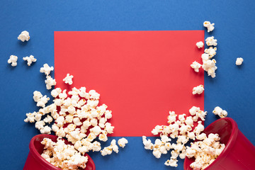 Popcorn on blue background and red empty card