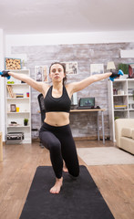 Young caucasian woman doing lunges at home