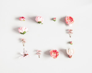Flowers composition. Frame made of pink flowers on pastel gray background. Valentines day, mothers day, womens day concept. Flat lay, top view, copy space