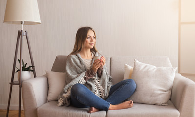 Calm girl drinking coffee, relaxing at home, free space