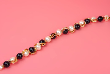 vintage elegant jewelry on pink background