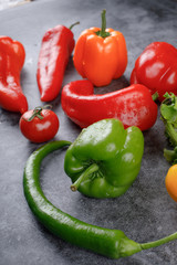 Fresh red and green peppers with water drops.