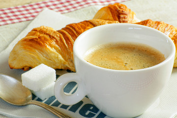 tasse de café et croissant sur une table