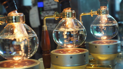 Fototapeta na wymiar Boiling water in vacuum pot or siphon pot. Vacuum pot coffee maker.