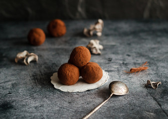 Chocolate homemade truffles. Tasty sweets on the table. Cocoa sprinkled sweets