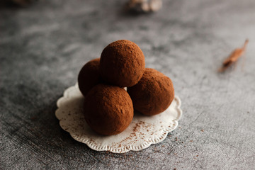 Chocolate homemade truffles. Tasty sweets on the table. Cocoa sprinkled sweets