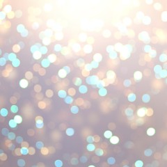 Golden and blue bokeh on beige blur background. Glitter texture. Garland lights pattern.