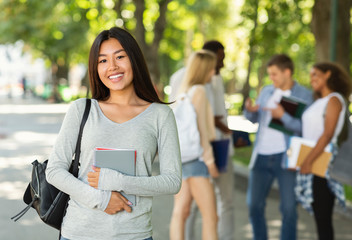 Happy asian girl student smiling at camera