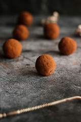 Chocolate homemade truffles. Tasty sweets on the table. Cocoa sprinkled sweets