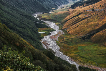 Scenic landscape with mountain river and small lake and blue mountains view from a top