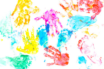 multicolored prints of children's hands and feet on white background. Abstract painted background....