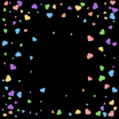 Background from bright multi-colored confetti. Festive heart shaped confetti. Joyful confetti on a black background. Bright colorful background.