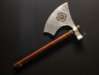 antique medieval old axe with wooden handle on black background - obrazy, fototapety, plakaty