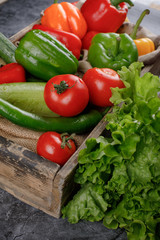 Fresh vegetables with lettuce in a wooden tray.