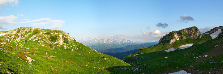 Fototapeta premium Green grassy meadow on a hillside on top of mountain ridge. Adygea, Lago-naki, Lagonaki, Krasnodar, Russia.