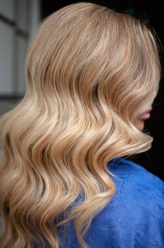 Long hair of a blonde woman with wave hairstyle