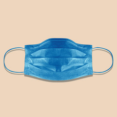 Typical 3-ply medical mask isolated on pink. hard lighted, harsh shadow. Blue surgical ear-loop mask. Surgical mask with rubber ear straps to cover the mouth and nose. Procedure mask from bacteria.
