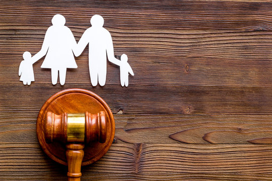 Family law concept with judge gavel on dark wooden background top-down copy space