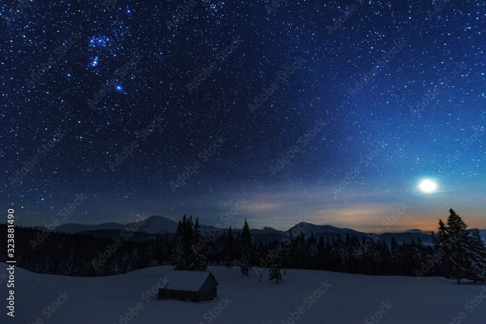 Wall mural a bright starry night in the mountains with the milky way in the sky, venus and millions of stars hi