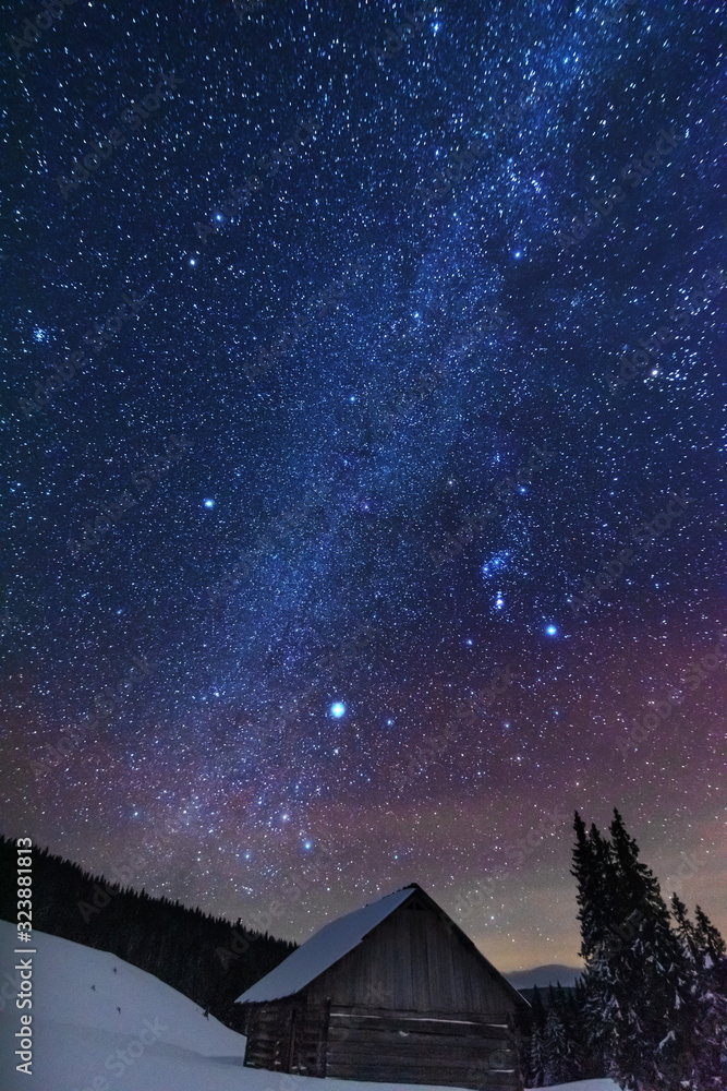 Wall mural a bright starry night in the mountains with the milky way in the sky, venus and millions of stars hi