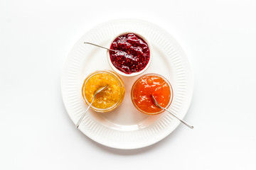 Fruit jams. Colorful dessert in bowls on white kitchen desk