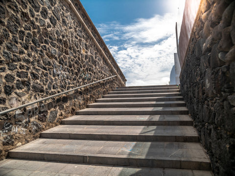 Beautiful image of long big old stone stairs on street against blue sky
