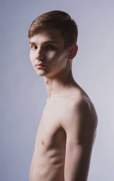 Portrait of a young brown-haired man with a naked torso, a view from the back and a full-face portrait