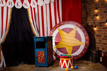 Circus backstage in retro style, drum on aa pedestal. Red stripped curtain background with various circus objects. Circus Theater stage. Old circus arena interior - obrazy, fototapety, plakaty